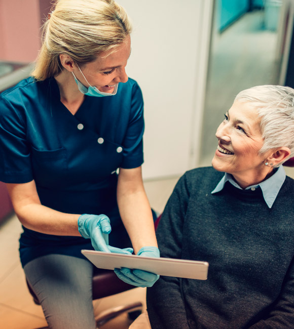 woman at dentist appointment viewing xrays with dentist
